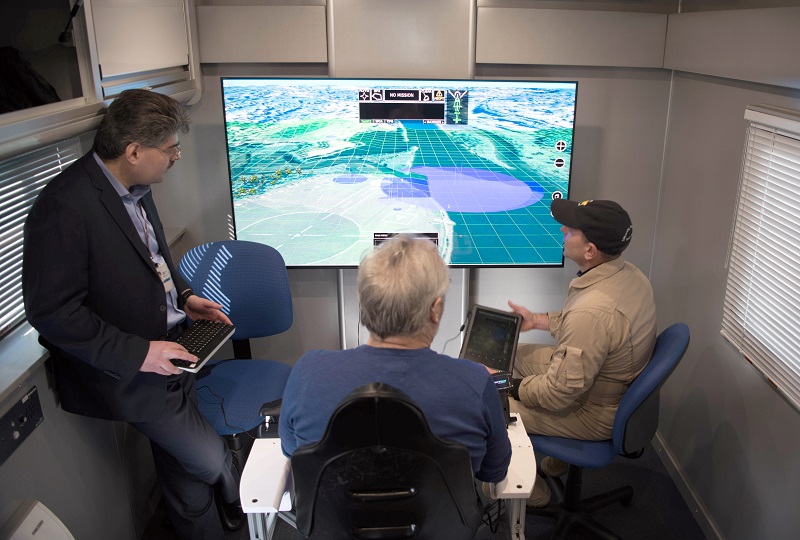team sitting around screen
